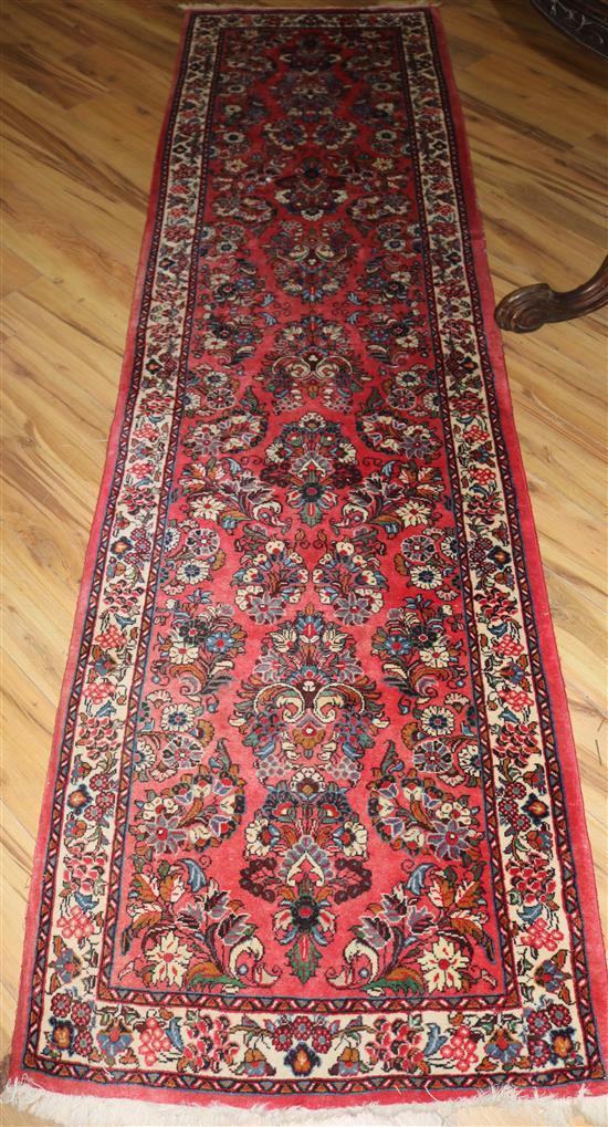 A Persian red ground runner 10ft 2in by 2ft 9in.